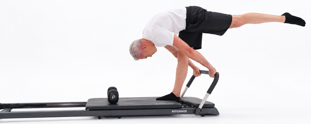 PAVO Reformer supporting a Pilates balance exercise